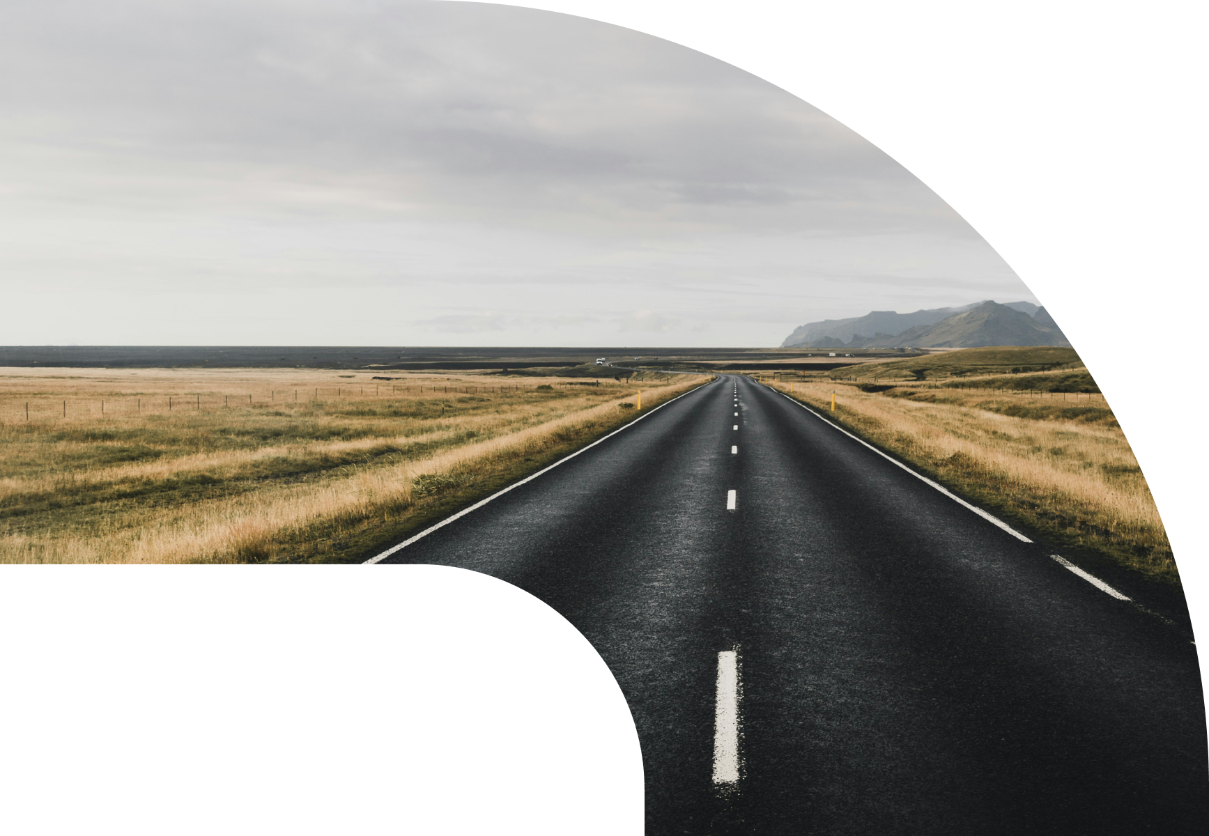 A winding open road through a dramatic travel landscape